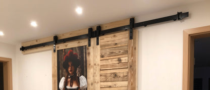 Casa vintage barn door system on rustic wooden door in black forest style