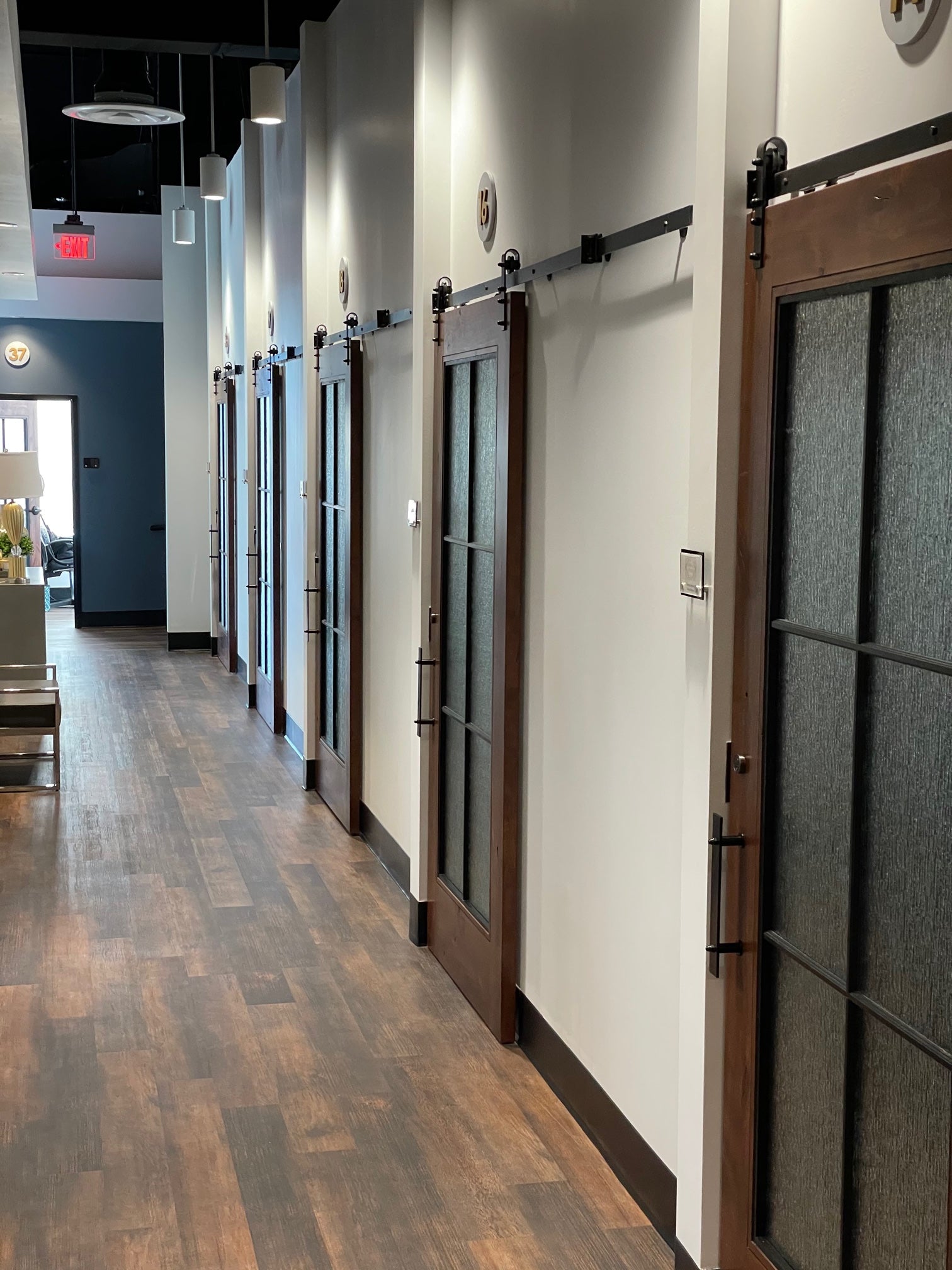 Vintage barn door hardware Casa installed on wooden doors at a cosmetic salon