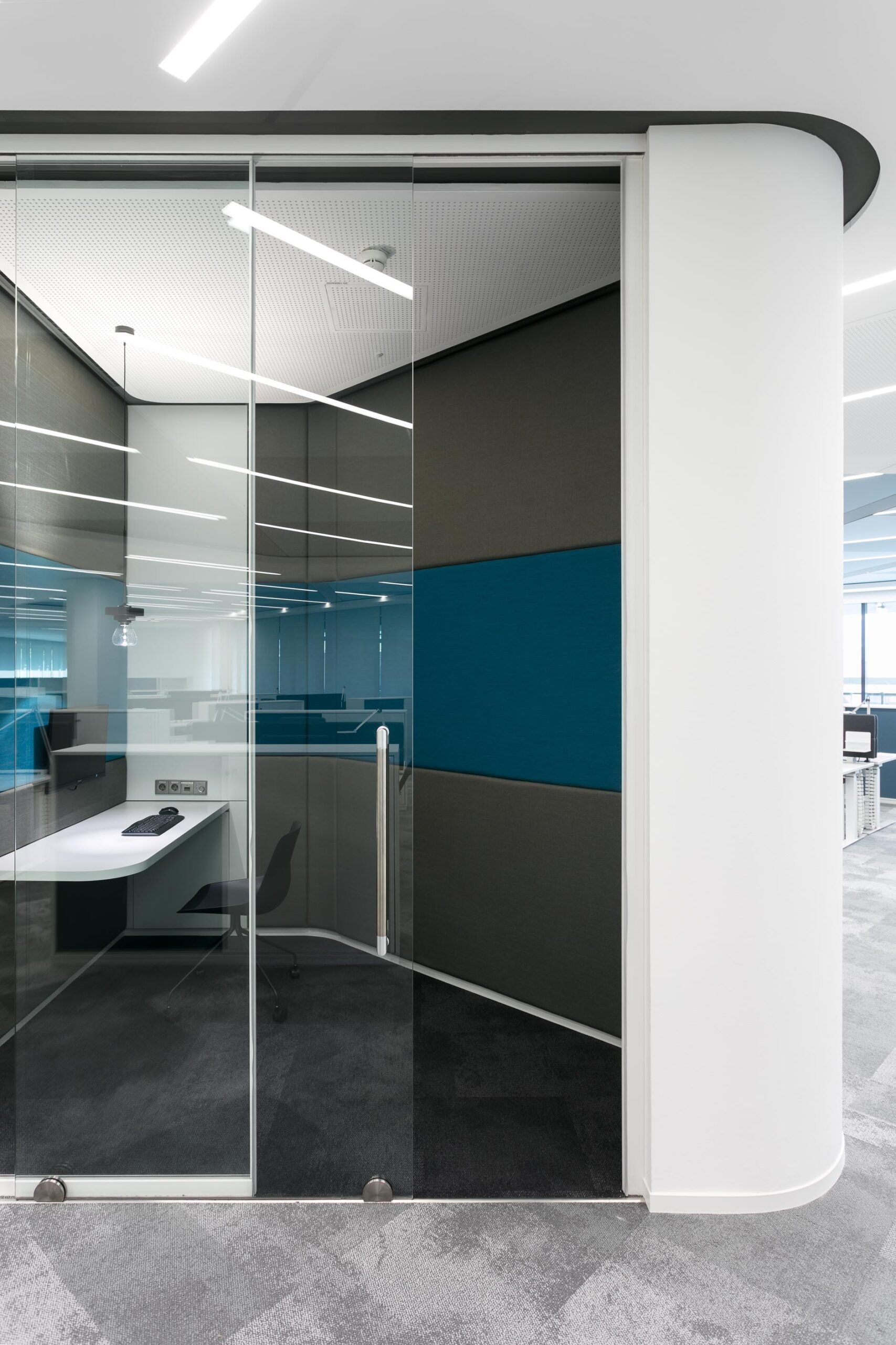 Base bottom roller system Belans mounted on glass door in an office room