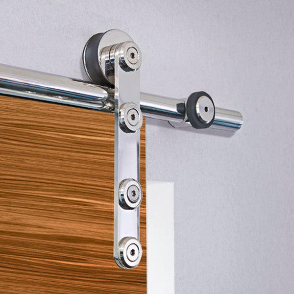 Barn door hardware Flatec IV in polished stainless steel mounted on wooden door