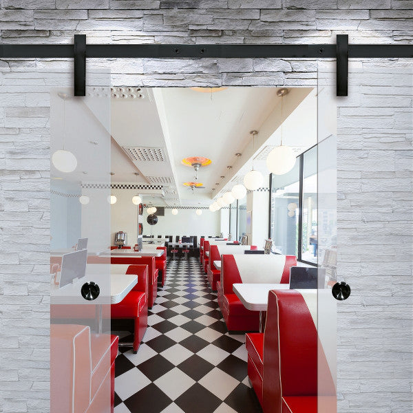 Runway sliding door hardwrae in steel black installed on a glass door in a diner restaurant