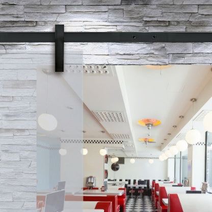 Runway sliding door hardwrae in black installed on a glass door