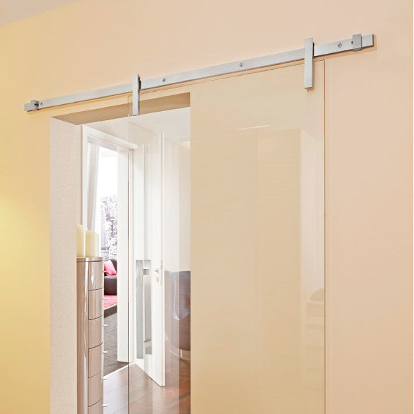 Sliding door hardware Runway in satin stainless steel mounted on a glass sliding door